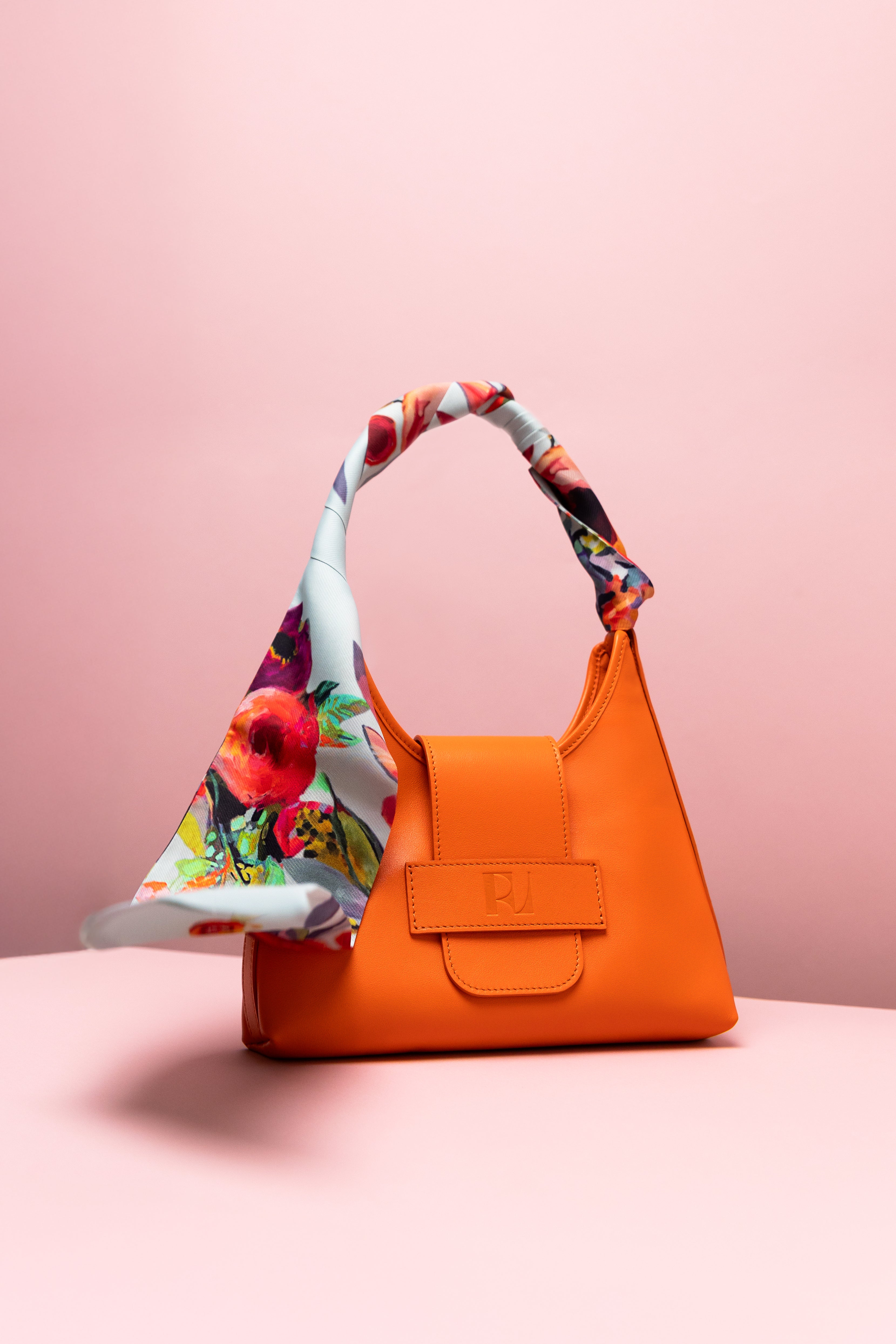 le foulard Mistral printemps noué autour de l'anse du sac Hobo orange